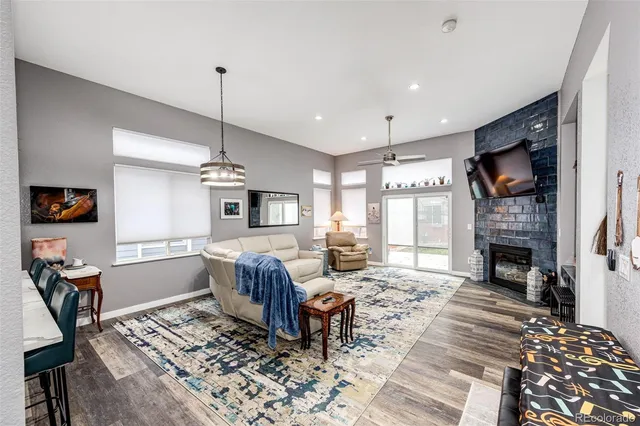 a living room with furniture fireplace and window