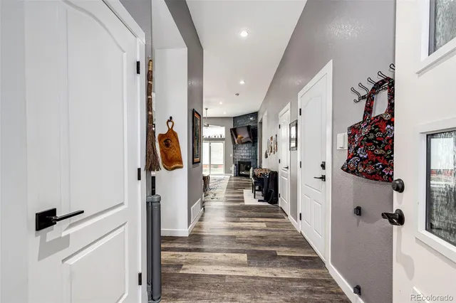 a view of a hallway with wooden floor and staircase