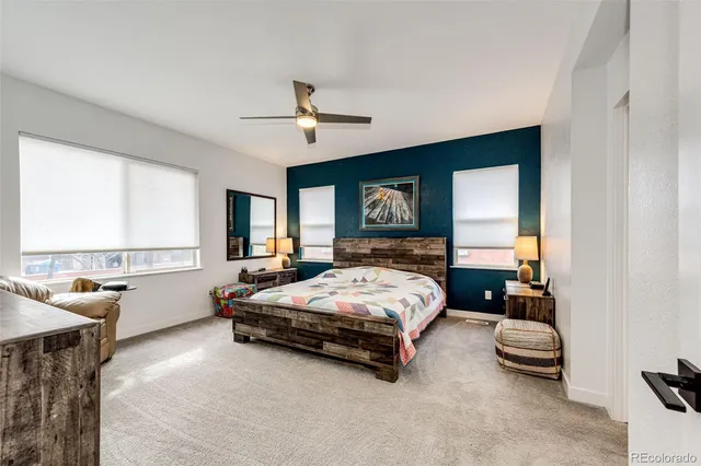 a spacious bedroom with a bed a couch and a window