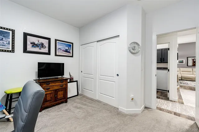 a view of a livingroom with furniture and flat screen tv