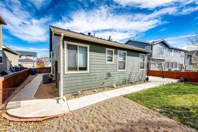 a front view of a house with a yard outdoor seating and garage