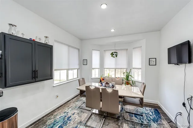 a living room with furniture a flat screen tv and a window