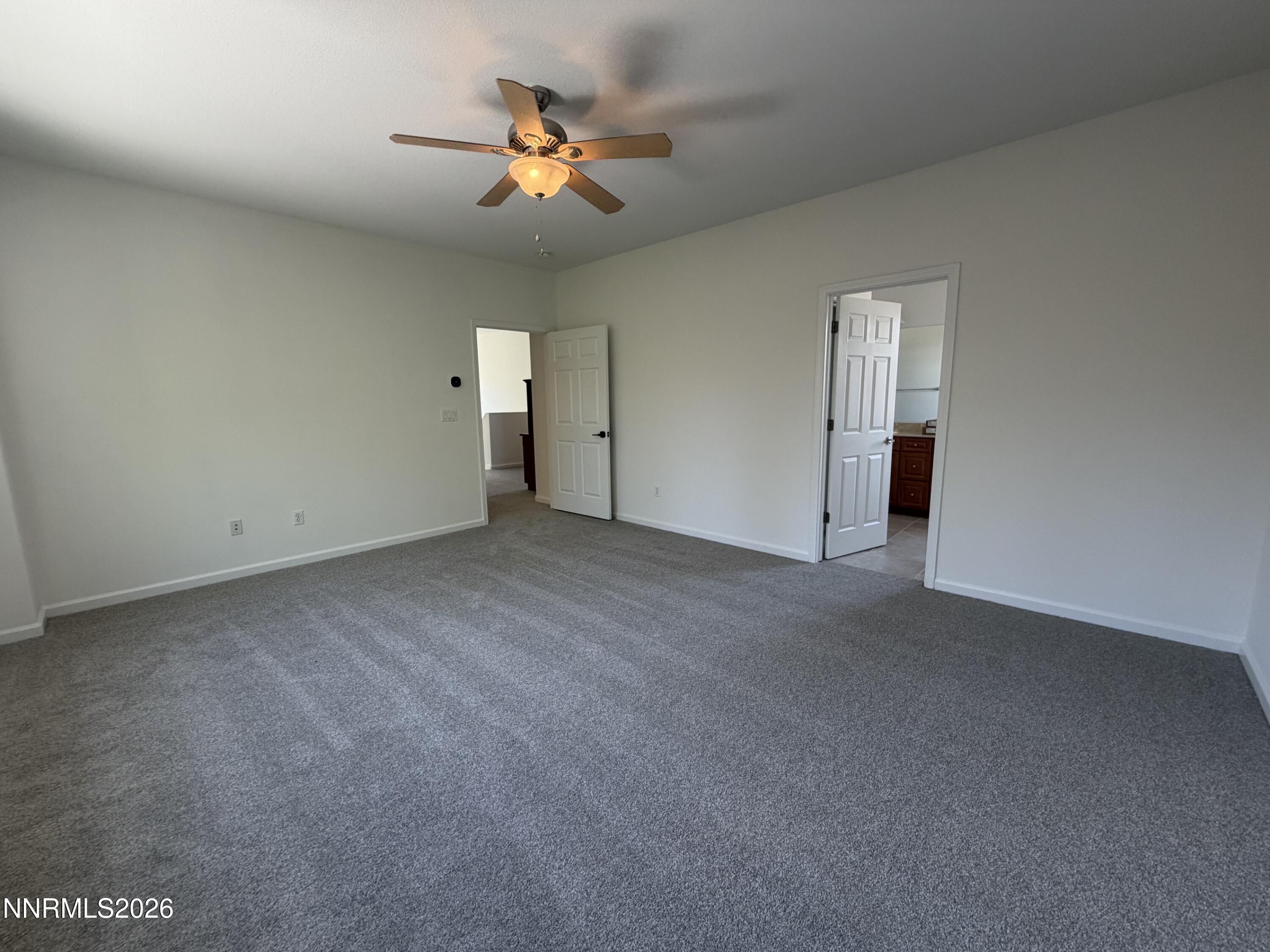 10890 Oakhaven Drive Reno, NV 89521 - Photo 14 of 28 a view of an empty room with a chandelier fan