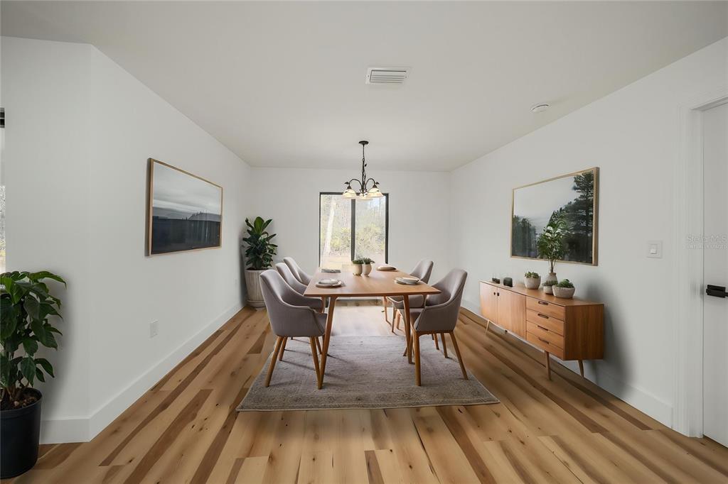 15460 Chamberlain Boulevard Port Charlotte, FL 33953 - Photo 17 of 24 a view of a dining room with furniture window and wooden floor