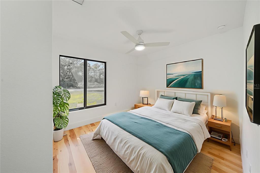 15460 Chamberlain Boulevard Port Charlotte, FL 33953 - Photo 10 of 24 a bedroom with a bed table and a window