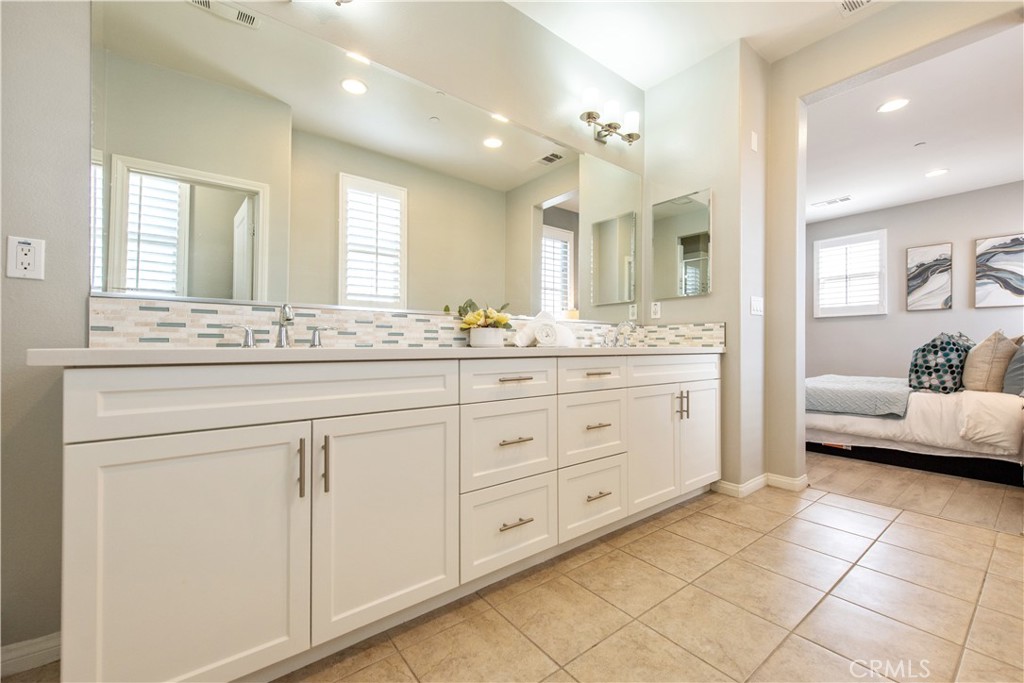 68 Origin Irvine, CA 92618 - Photo 33 of 43 a spacious bathroom with a granite countertop sink a toilet and a mirror