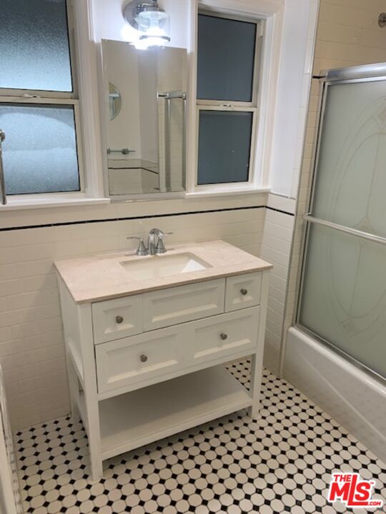 312 South Reeves Drive, Unit E Beverly Hills, CA 90212 - Photo 6 of 10 a bathroom with a sink a vanity and a mirror