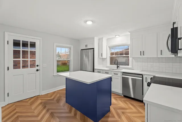 a kitchen with a sink stove and cabinets
