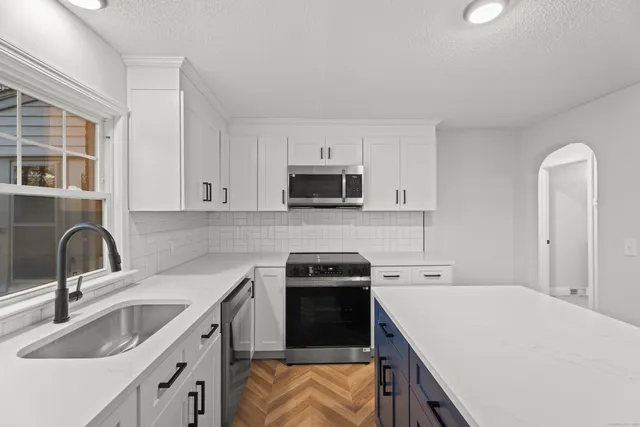 a kitchen with a sink stove and microwave