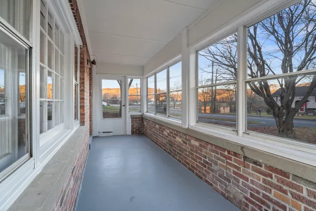 a view of a porch with wooden floor and fence
