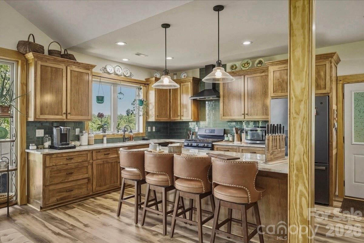 5564 Table View Lane Lenoir, NC 28645 - Photo 17 of 48 a kitchen with kitchen island granite countertop a table chairs sink and cabinets