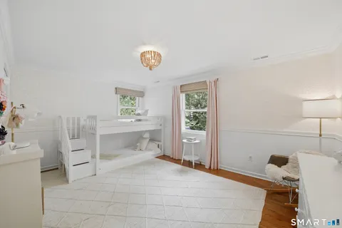 a spacious bedroom with a bed and a table in it