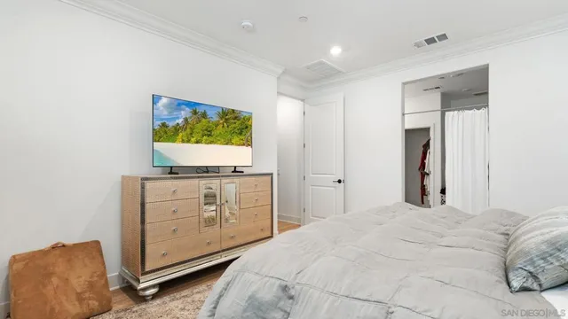 a bedroom with a bed and a flat screen tv