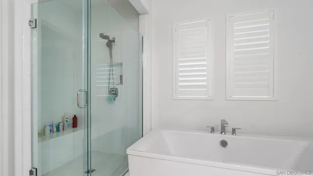 a white bath tub sitting next to a white sink
