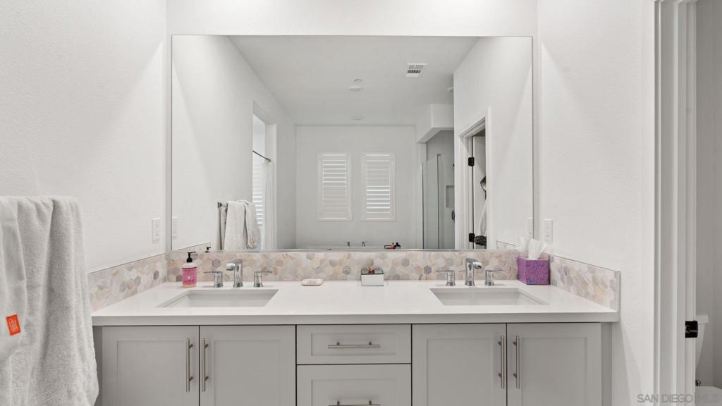 15681 Rennyson Way San Diego, CA 92127 - Photo 18 of 36 a bathroom with a sink and a mirror