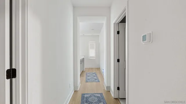 a view of a hallway with a walk in closet