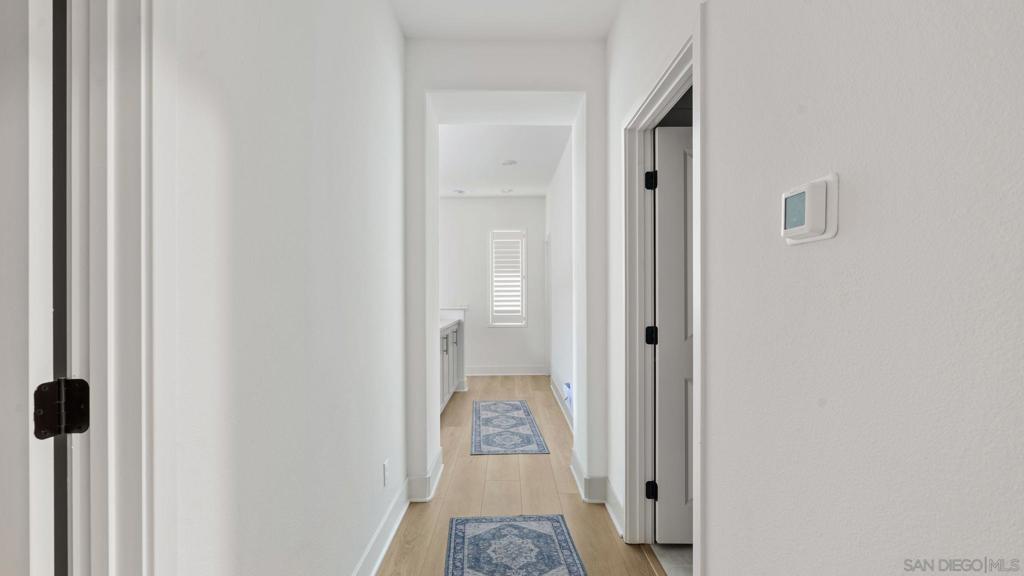 15681 Rennyson Way San Diego, CA 92127 - Photo 20 of 36 a view of a hallway with a walk in closet