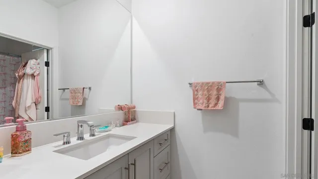 a bathroom with a sink vanity and a mirror