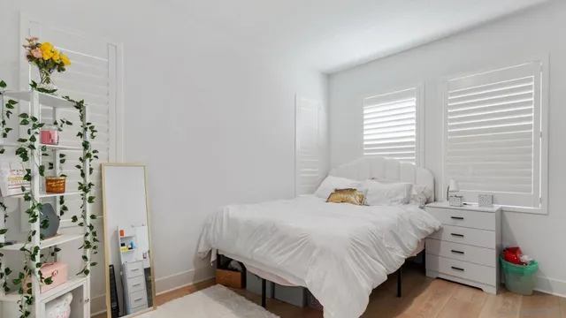 a bedroom with a bed and a window