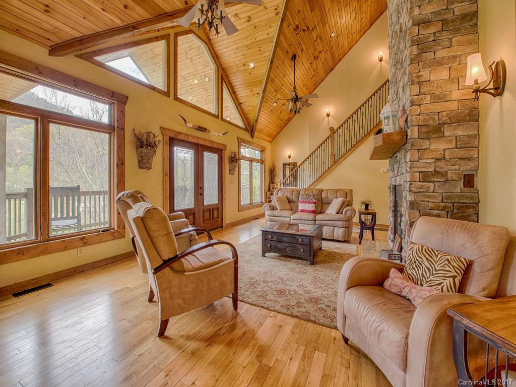 295 Rice Cove Road Canton, NC 28716 - Photo 11 of 24 a living room with furniture and a floor to ceiling window