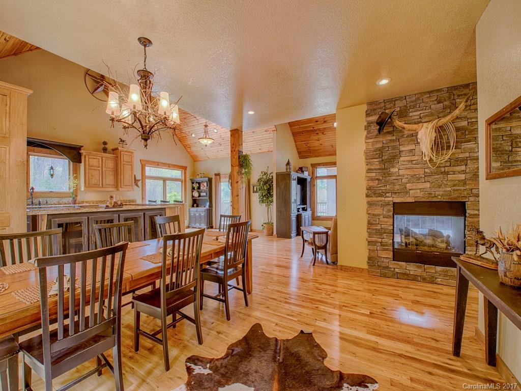 295 Rice Cove Road Canton, NC 28716 - Photo 13 of 24 a view of a livingroom with furniture a fireplace and chandelier