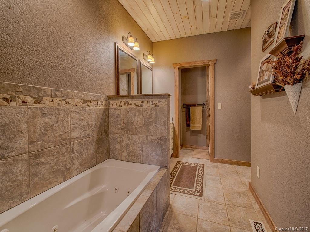 295 Rice Cove Road Canton, NC 28716 - Photo 17 of 24 a bathroom with a bathtub and shower