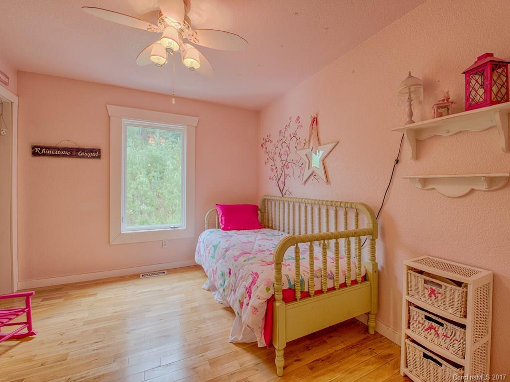 295 Rice Cove Road Canton, NC 28716 - Photo 21 of 24 a bedroom with furniture and a window