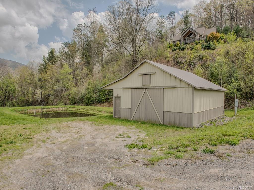295 Rice Cove Road Canton, NC 28716 - Photo 4 of 24 a view of a small house with a yard