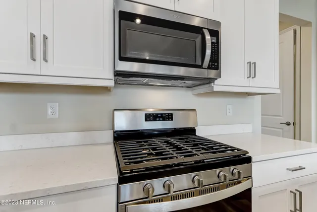 a stove top oven sitting inside of a kitchen