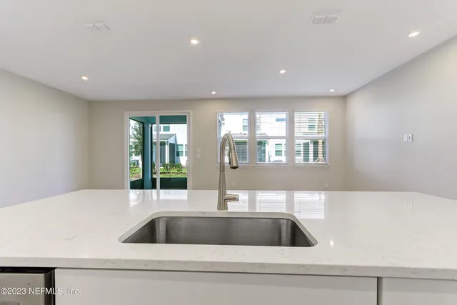 a kitchen with a sink and cabinet