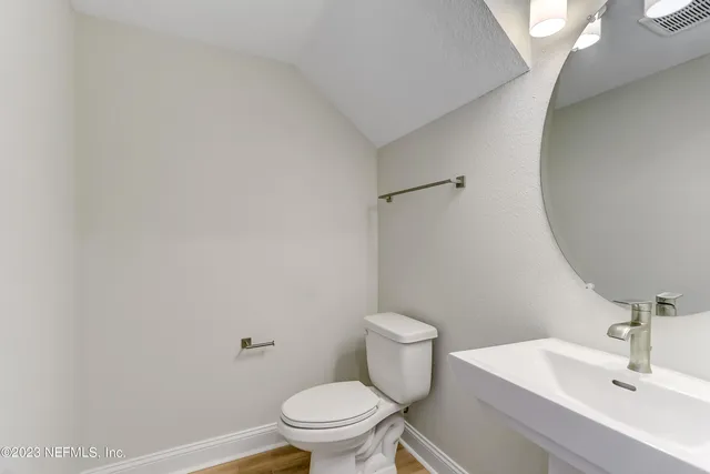 a white toilet sitting next to a bathroom sink