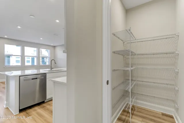 a bathroom with a granite countertop sink and washing machine