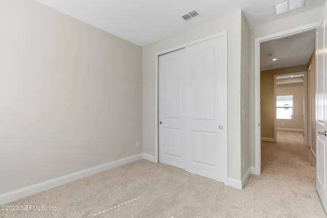 a view of an empty room and closet