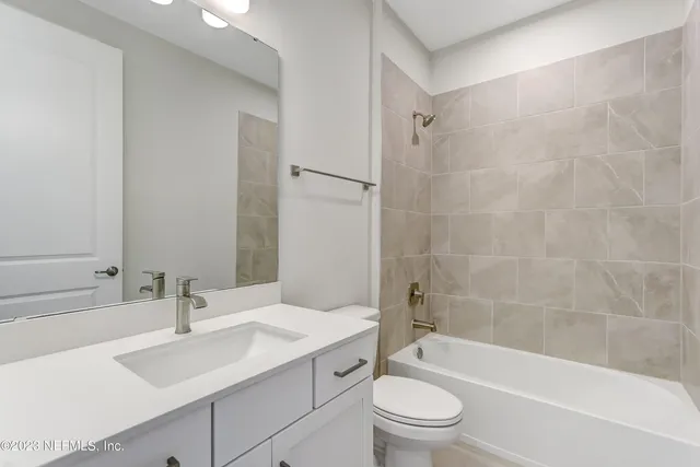 a bathroom with a sink a toilet and a bathtub