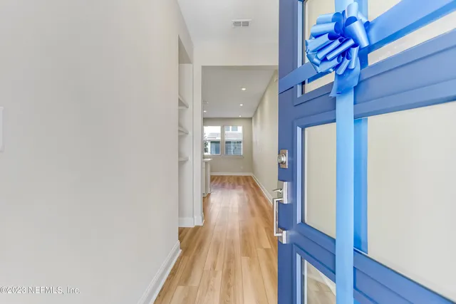 a view of hallway with wooden floor