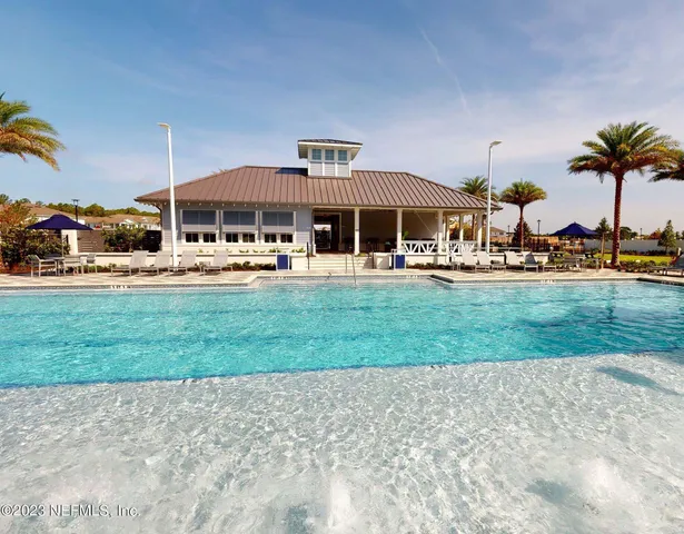 a patio with a table and chairs under an umbrella
