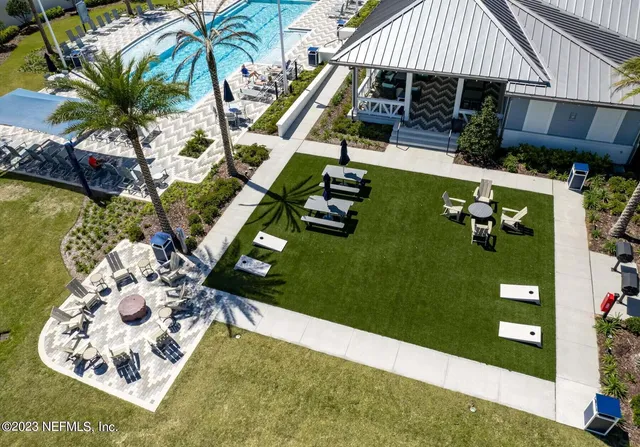 a living room with couch and a floor to ceiling window
