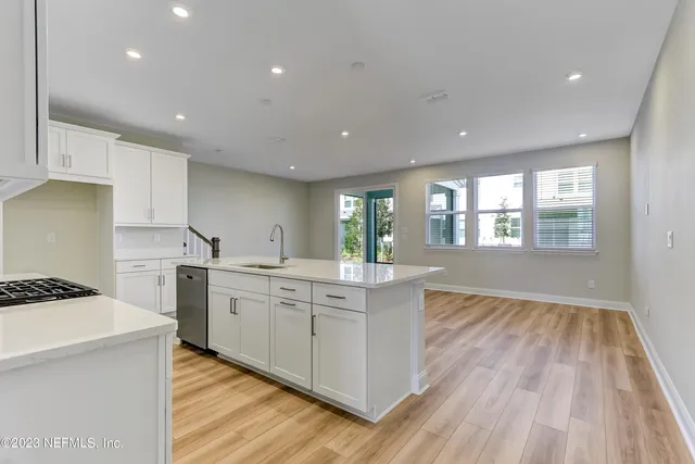 a kitchen with sink a stove and refrigerator