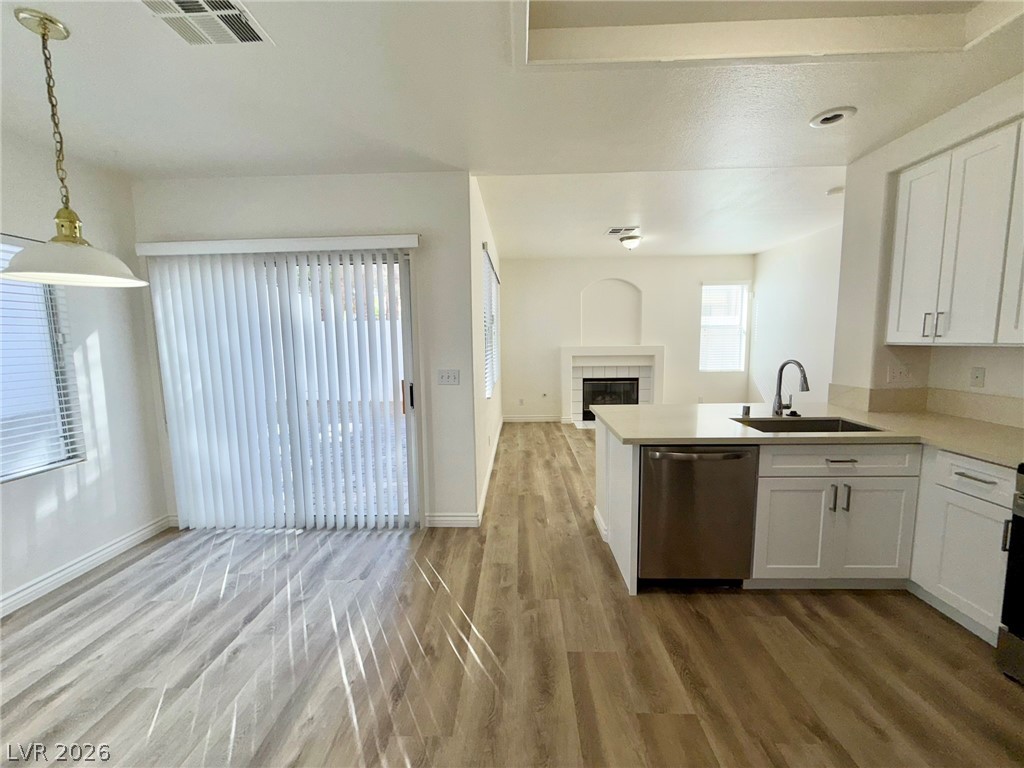 9729 Trail Rider Drive Las Vegas, NV 89117 - Photo 26 of 26 An open floor plan seamlessly connects the kitchen and living area, featuring an inviting fireplace and easy outdoor access.