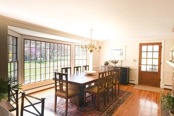 123 Draper Road Wayland, MA 01778 - Photo 3 of 30 a view of a dining room with furniture large windows and wooden floor