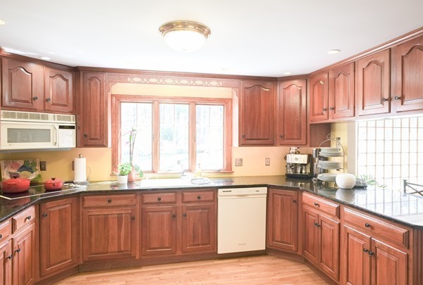 123 Draper Road Wayland, MA 01778 - Photo 5 of 30 a kitchen with stainless steel appliances wooden cabinets a sink and a window