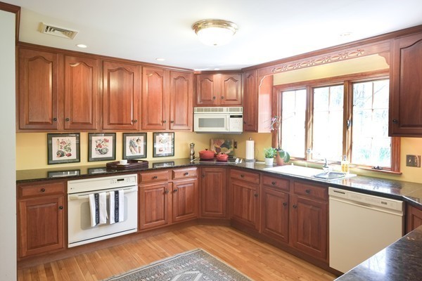123 Draper Road Wayland, MA 01778 - Photo 10 of 30 a kitchen with stainless steel appliances granite countertop wooden cabinets a sink and dishwasher with wooden floor