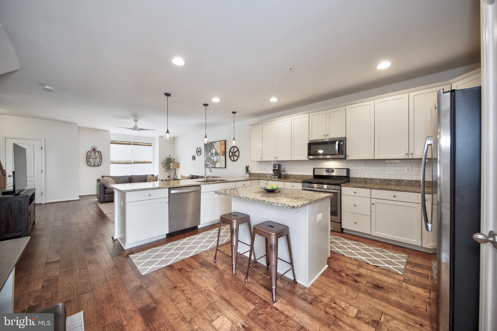 909 Morgan Run Road Baltimore, MD 21220 - Photo 11 of 41 a kitchen with white cabinets and white appliances