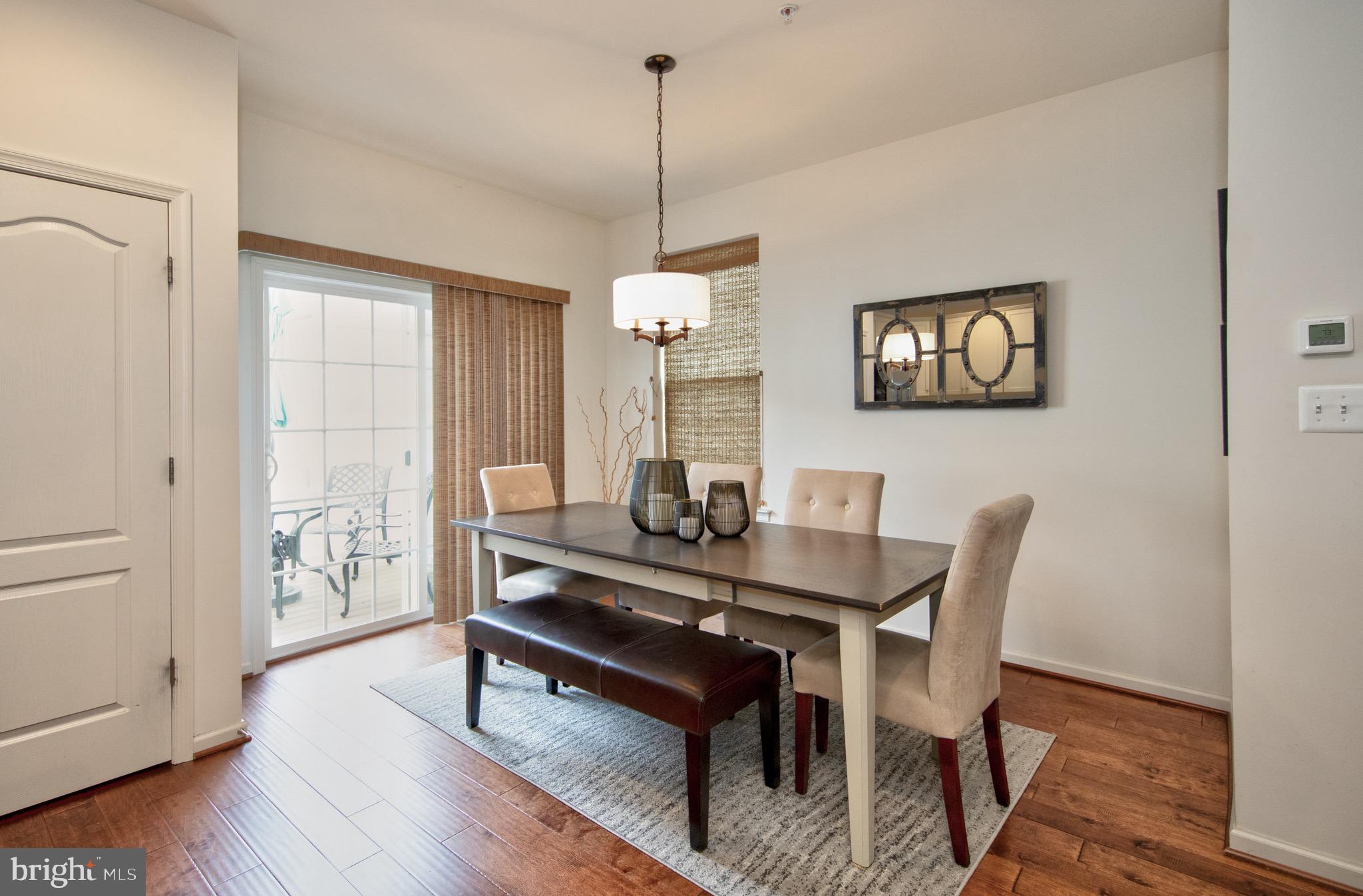 909 Morgan Run Road Baltimore, MD 21220 - Photo 14 of 41 a view of a dining room with furniture window and wooden floor
