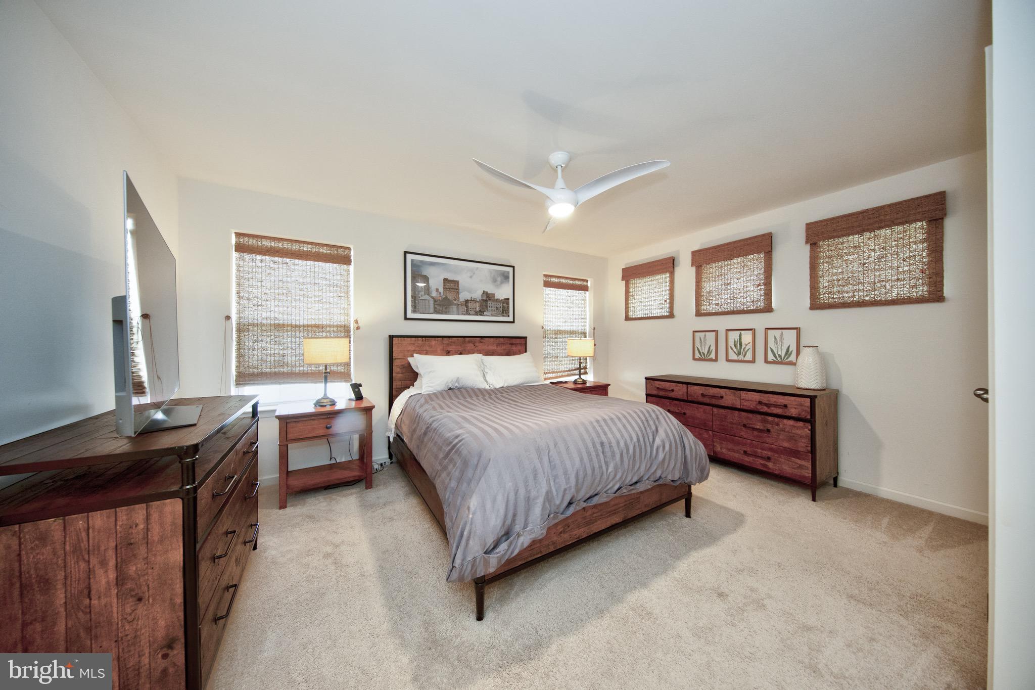 909 Morgan Run Road Baltimore, MD 21220 - Photo 29 of 41 a bedroom with a bed and a dresser next to a window