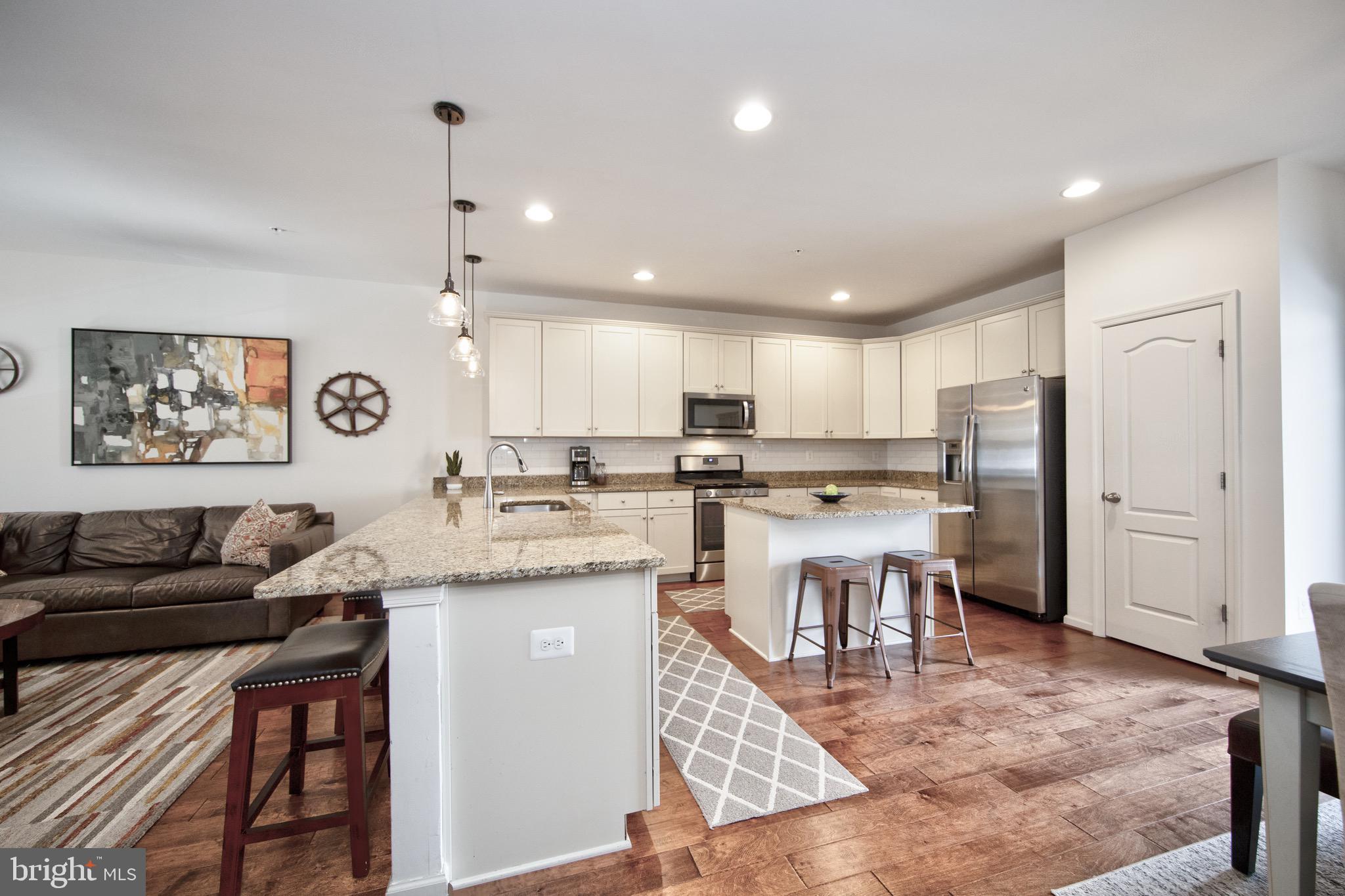 909 Morgan Run Road Baltimore, MD 21220 - Photo 10 of 41 a living room with stainless steel appliances kitchen island granite countertop furniture and a view of kitchen