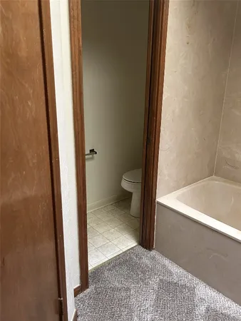 a bathroom with a tub sink and mirror