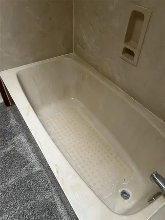 a view of a room with a ceiling fan