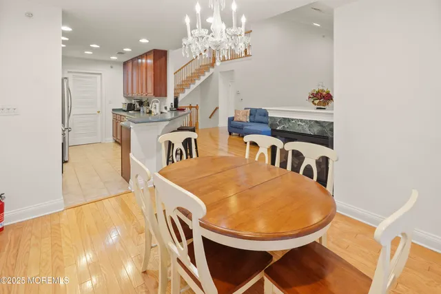 a view of a dining room with furniture and a chandelier