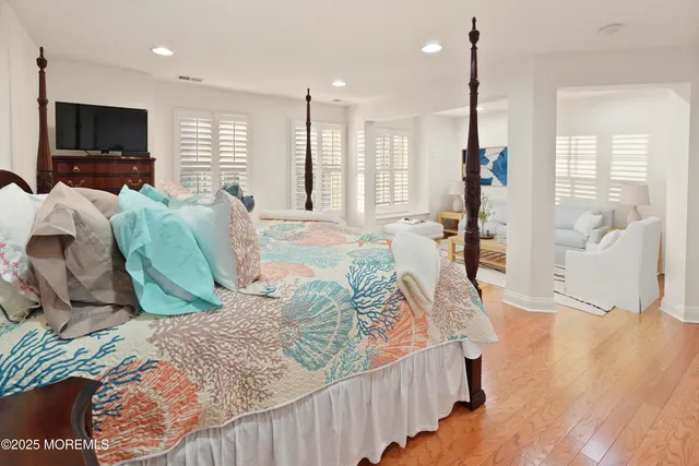 a bed room with a bed window and a flat screen tv